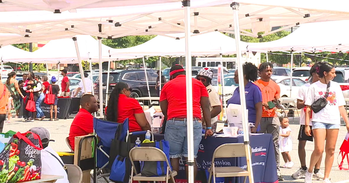 What is the purpose of the community block party in West Baltimore?