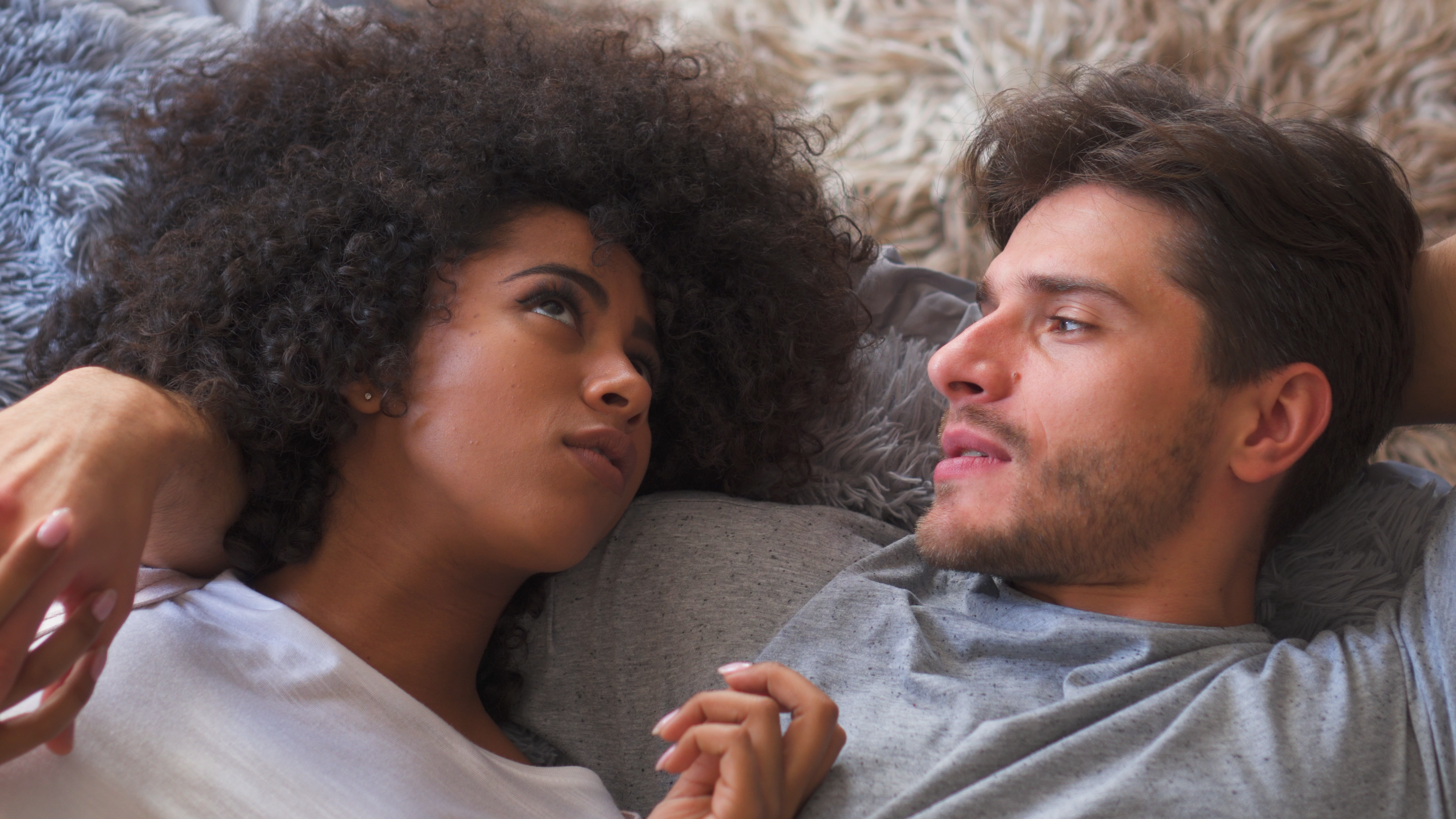 A couple sharing a romantic moment during the holiday season, symbolizing intimacy despite family gatherings.